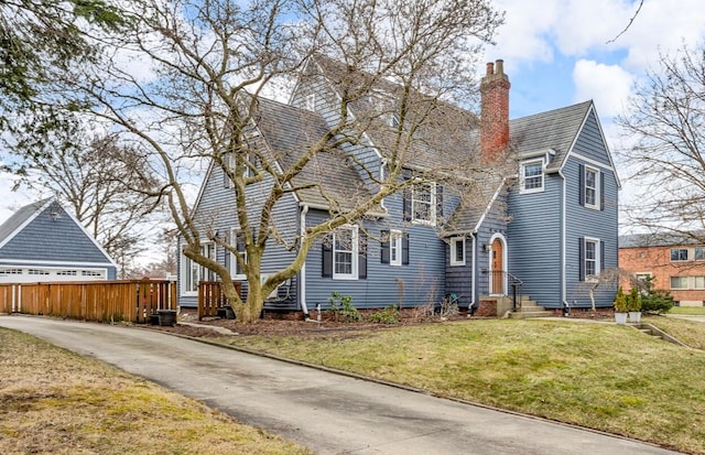 1515 W Franklin St, Jackson, MI 49203 - view of front of property featuring a chimney, fence, concrete driveway, and a front yard