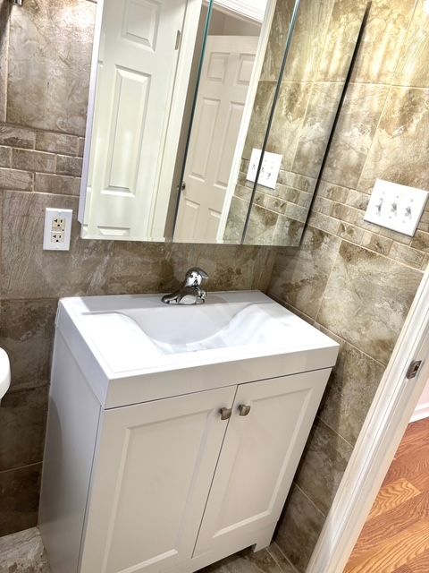 35030 Michelle Dr, Romulus, MI 48174 - bathroom with vanity and tile walls