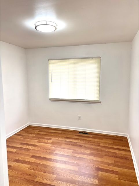 35030 Michelle Dr, Romulus, MI 48174 - spare room with wood finished floors, baseboards, and visible vents