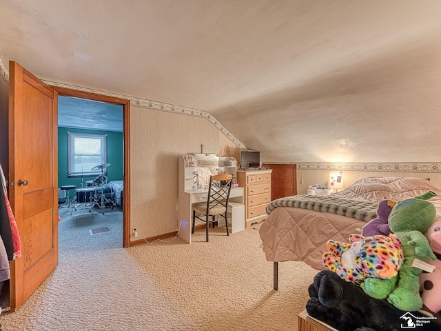 bedroom with lofted ceiling, carpet flooring, and visible vents