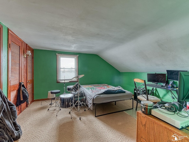carpeted bedroom featuring baseboards and lofted ceiling