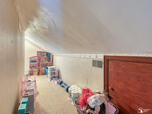 game room with vaulted ceiling, visible vents, carpet, and a textured ceiling
