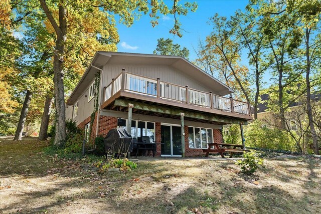 3155 Ridge Rd, White Lake, MI 48383 - rear view of property with a wooden deck and brick siding