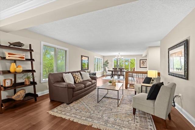 3155 Ridge Rd, White Lake, MI 48383 - living room with wood finished floors, a chandelier, baseboards, a textured ceiling, and healthy amount of natural light