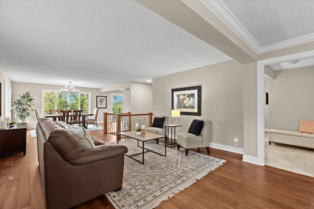 3155 Ridge Rd, White Lake, MI 48383 - living area with a textured ceiling, wood finished floors, a chandelier, baseboards, and ornamental molding