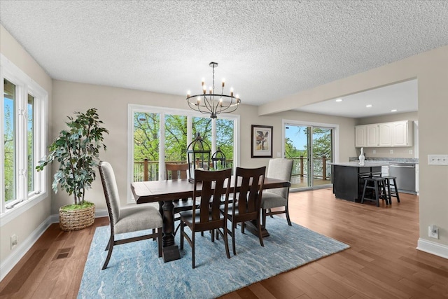 3155 Ridge Rd, White Lake, MI 48383 - dining space featuring a chandelier, a textured ceiling, wood finished floors, baseboards, and recessed lighting