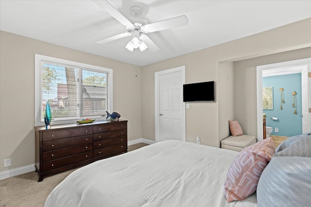 3155 Ridge Rd, White Lake, MI 48383 - bedroom with light carpet, baseboards, ceiling fan, and connected bathroom