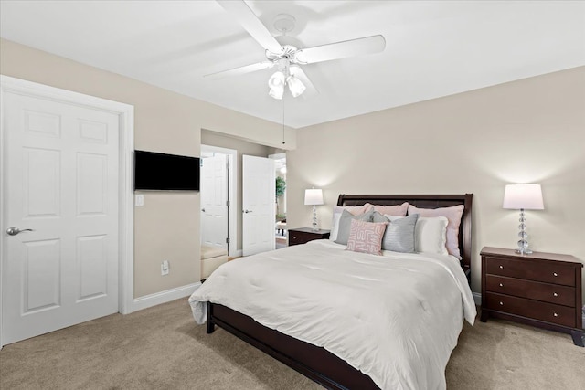 3155 Ridge Rd, White Lake, MI 48383 - bedroom with light colored carpet, a ceiling fan, and connected bathroom