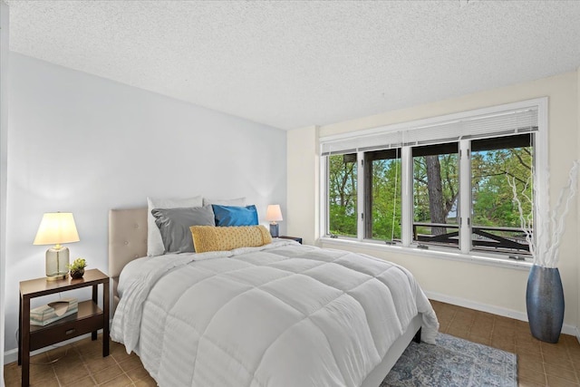 3155 Ridge Rd, White Lake, MI 48383 - bedroom featuring tile patterned flooring, a textured ceiling, and baseboards