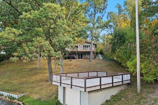 3155 Ridge Rd, White Lake, MI 48383 - rear view of house with a deck, a garage, and a lawn