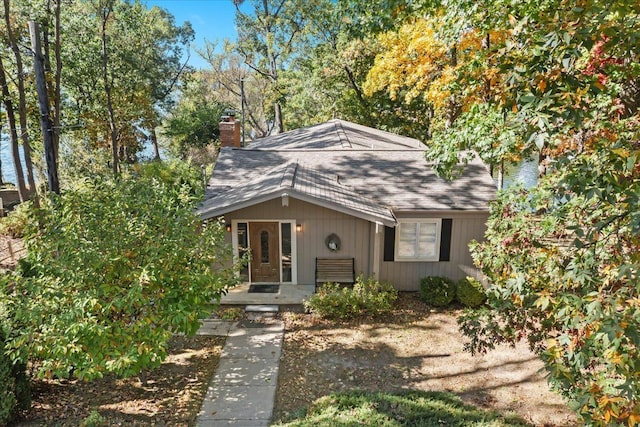 3155 Ridge Rd, White Lake, MI 48383 - view of front of property with a chimney and roof with shingles
