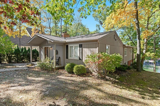 3155 Ridge Rd, White Lake, MI 48383 - view of front of house with a chimney