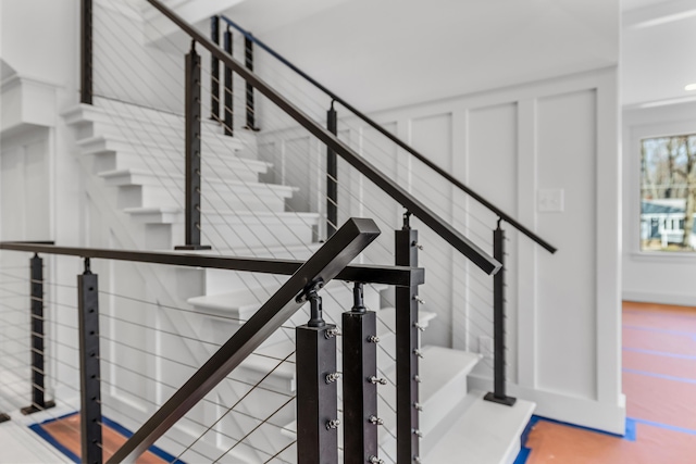 stairs featuring a decorative wall