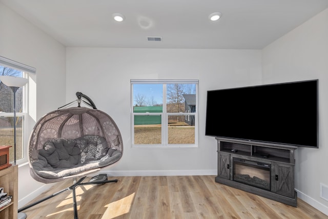 2084 W Fenwick Rd, Fenwick, MI 48834 - sitting room with visible vents, baseboards, wood finished floors, and a wealth of natural light