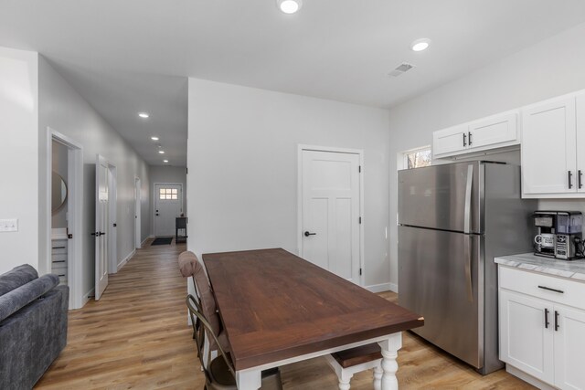 2084 W Fenwick Rd, Fenwick, MI 48834 - kitchen with white cabinets, freestanding refrigerator, recessed lighting, baseboards, and light wood-type flooring