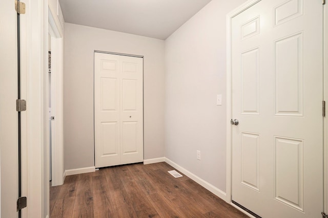 13662 Oasis Ave, Holland, MI 49424 - unfurnished bedroom with dark wood-style flooring and a closet