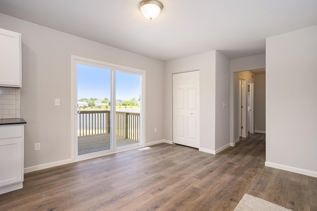13662 Oasis Ave, Holland, MI 49424 - unfurnished dining area with wood finished floors and baseboards