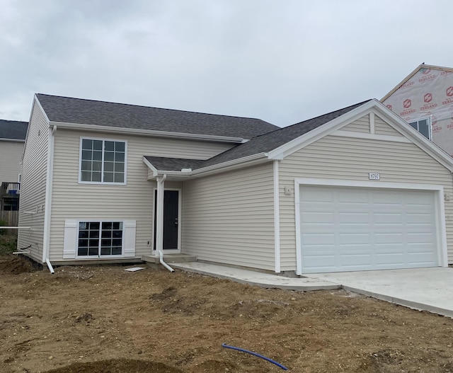 8797 E Sturtevant Ave, Richland, MI 49083 - tri-level home featuring driveway, a garage, and a shingled roof
