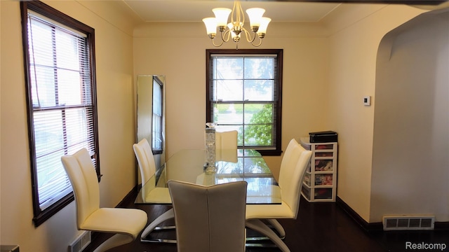 18229 Littlefield St, Detroit, MI 48235 - dining room with a chandelier, healthy amount of natural light, arched walkways, and baseboards