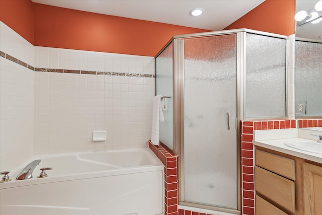 bathroom featuring a bath, vanity, recessed lighting, and a shower stall