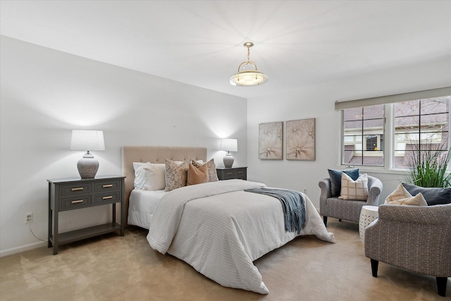 bedroom featuring baseboards and light carpet