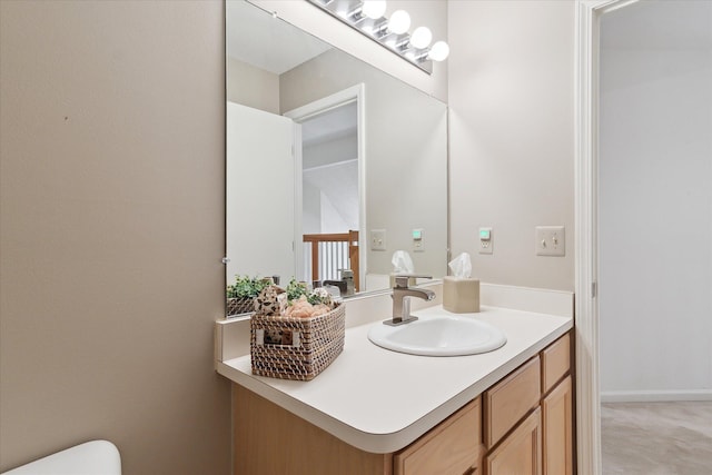 bathroom featuring toilet and vanity