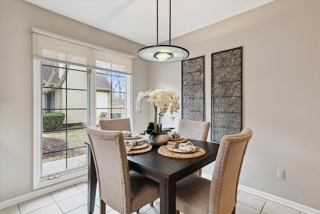dining room featuring baseboards and light tile patterned floors