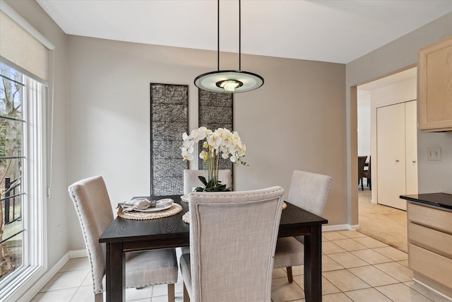 dining area with light tile patterned floors and baseboards