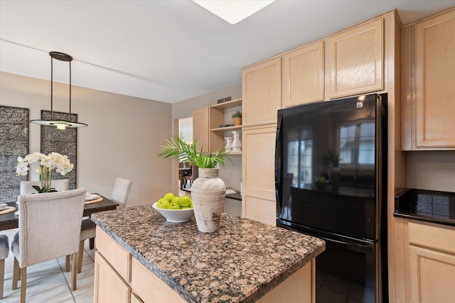 kitchen featuring visible vents, open shelves, light brown cabinetry, and freestanding refrigerator
