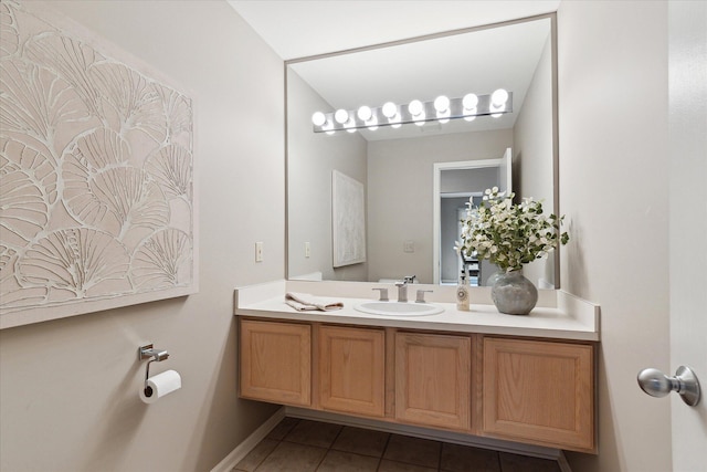 bathroom featuring baseboards, tile patterned flooring, and vanity