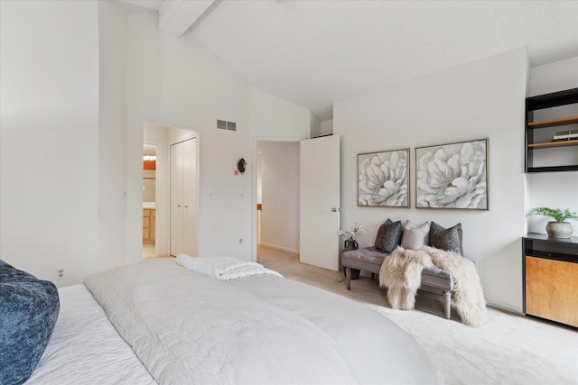 bedroom with light colored carpet, high vaulted ceiling, beamed ceiling, visible vents, and ensuite bathroom