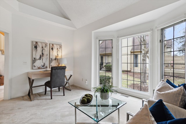 carpeted office featuring baseboards, a healthy amount of sunlight, vaulted ceiling, and visible vents
