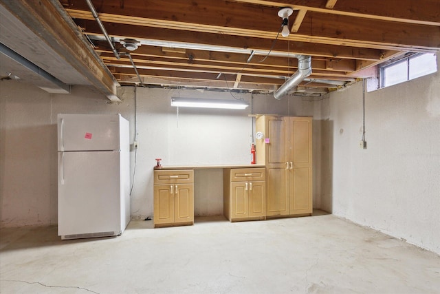below grade area with freestanding refrigerator
