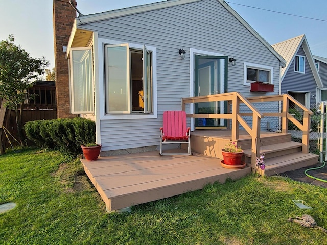 back of house featuring a chimney and a deck