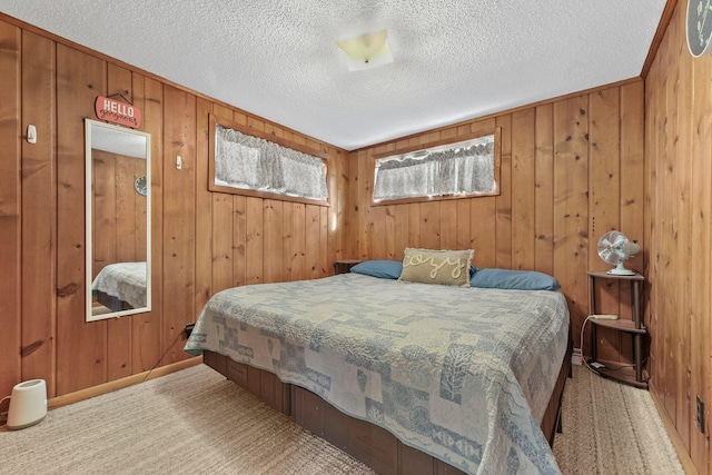 bedroom with carpet flooring, baseboards, and a textured ceiling