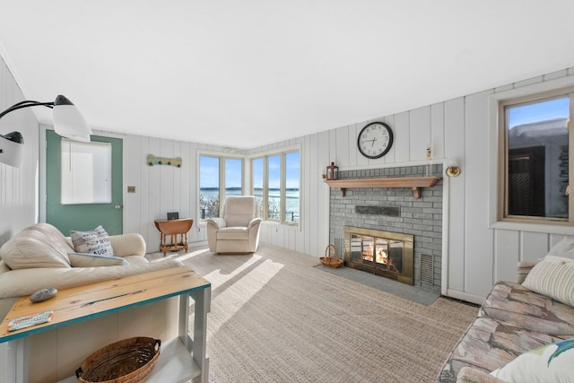 carpeted living room with a brick fireplace