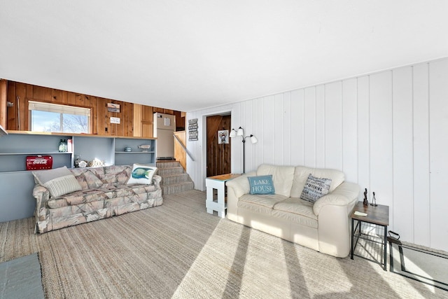 living area featuring carpet flooring and stairs