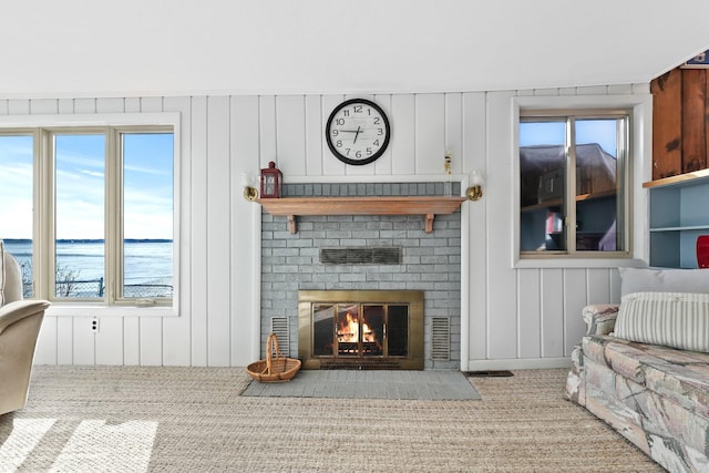 carpeted living room with a healthy amount of sunlight and a fireplace