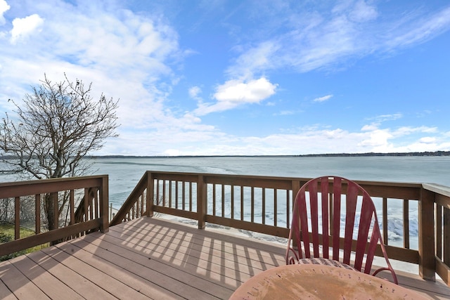 wooden terrace featuring a water view
