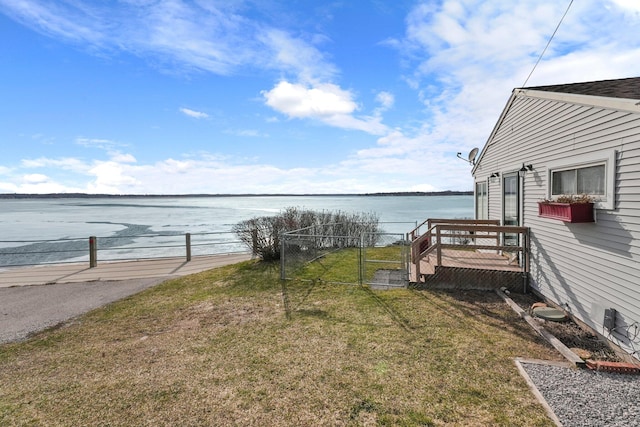view of yard featuring a water view and fence