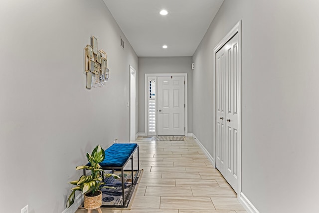 doorway to outside with visible vents, recessed lighting, baseboards, and wood finish floors