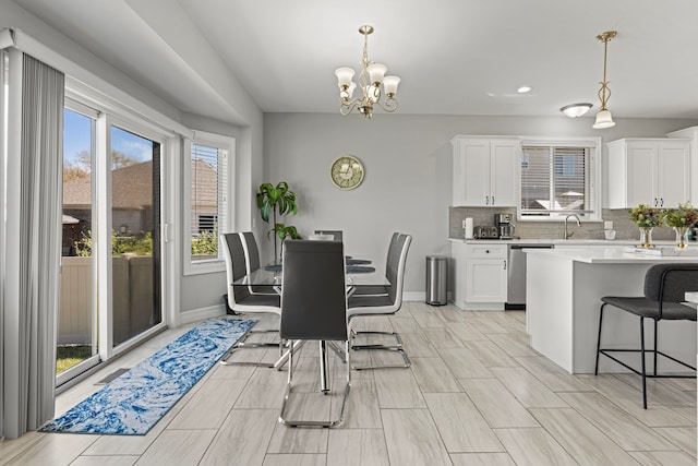 dining room with recessed lighting, baseboards, and an inviting chandelier