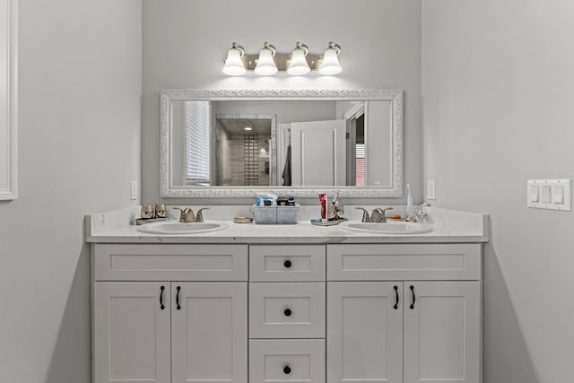 full bath with double vanity, a sink, and a shower