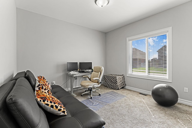 office area with carpet floors, baseboards, and visible vents