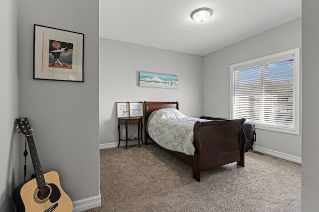 bedroom featuring carpet floors and baseboards