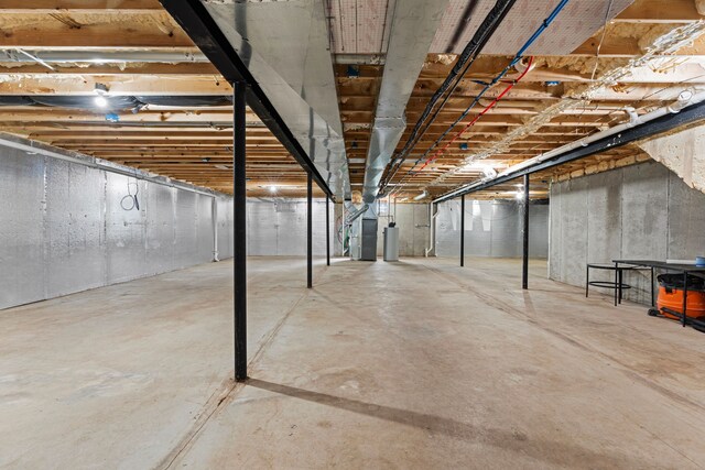 unfinished below grade area with heating unit and gas water heater