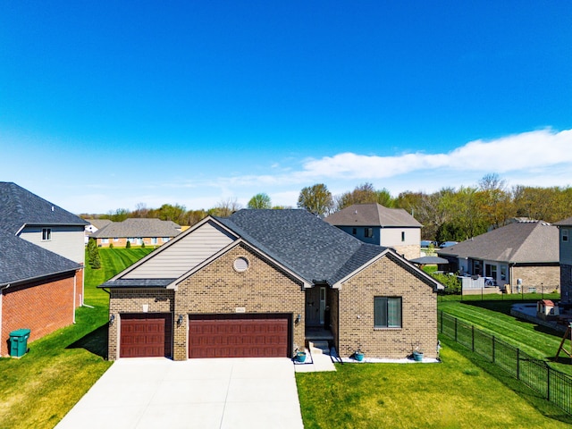 view of front of home with fence, a front lawn, brick siding, a garage, and driveway