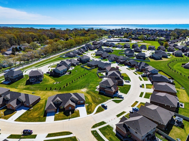 birds eye view of property with a water view and a residential view