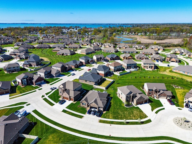 drone / aerial view with a water view and a residential view