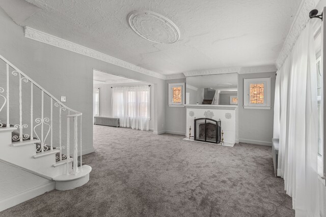 8735 Marygrove Dr, Detroit, MI 48221 - living room with a wealth of natural light, a tiled fireplace, carpet flooring, and a textured ceiling